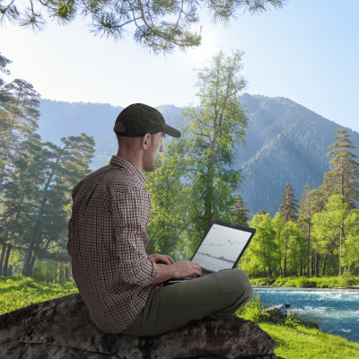 man working at laptop in nature